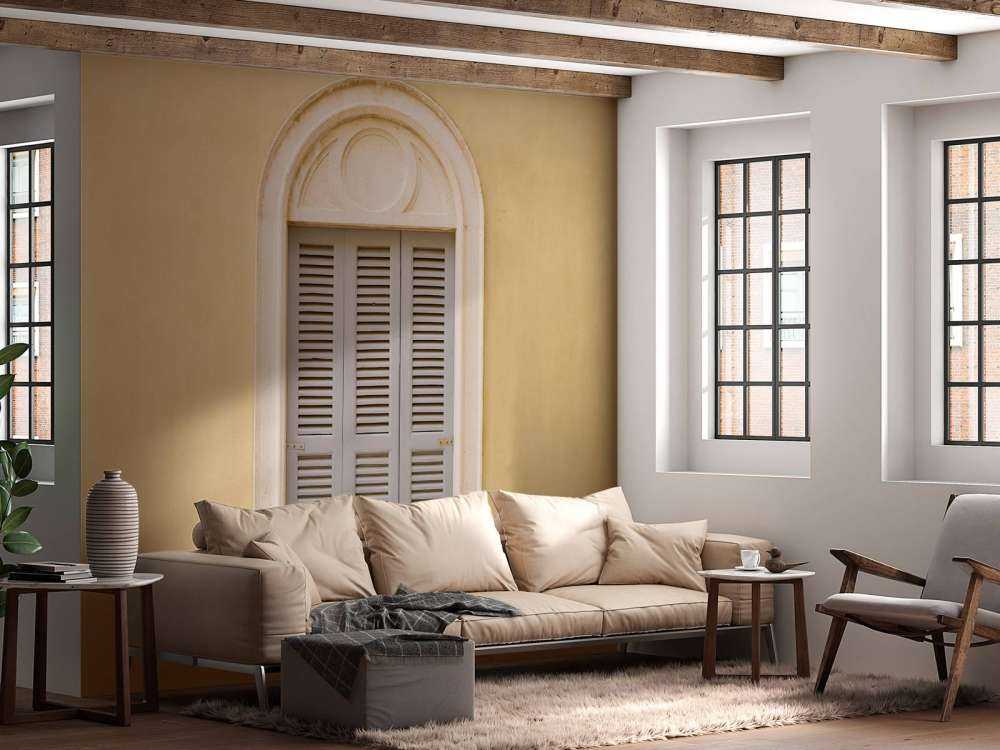 Finestra con persiane in legno su parete gialla