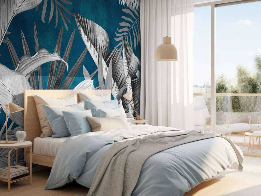 Foglie tropicali su sfondo blu