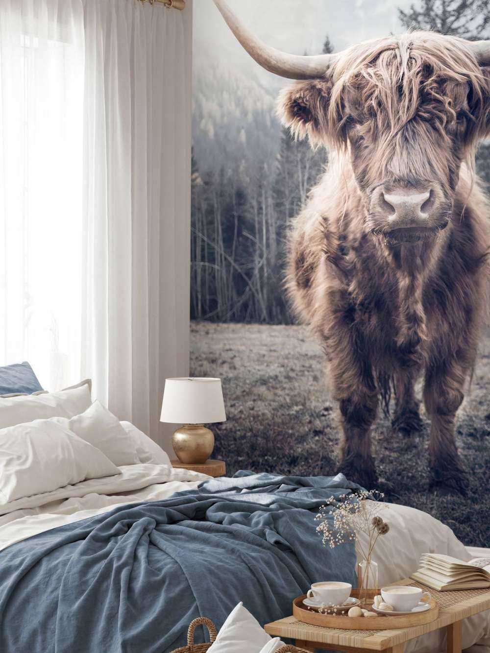 Highlander scozzese vicino alla foresta