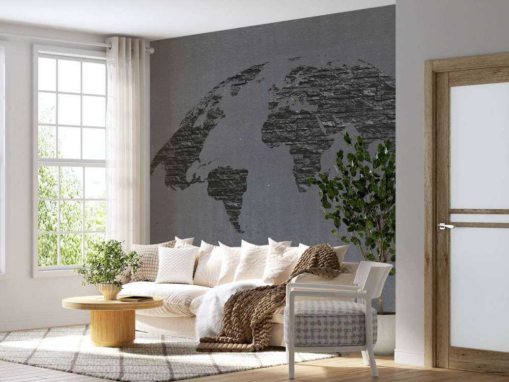 Pietre della mappa del mondo su cemento grigio